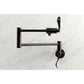 Kingston Brass KS4103DFL NuWave Wall Mount Pot Filler Faucet, Antique Brass on a marble background.