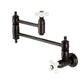 Kingston Brass KS310PXAC Restoration Wall Mount Pot Filler Faucet, Antique Copper with white ceramic handles.