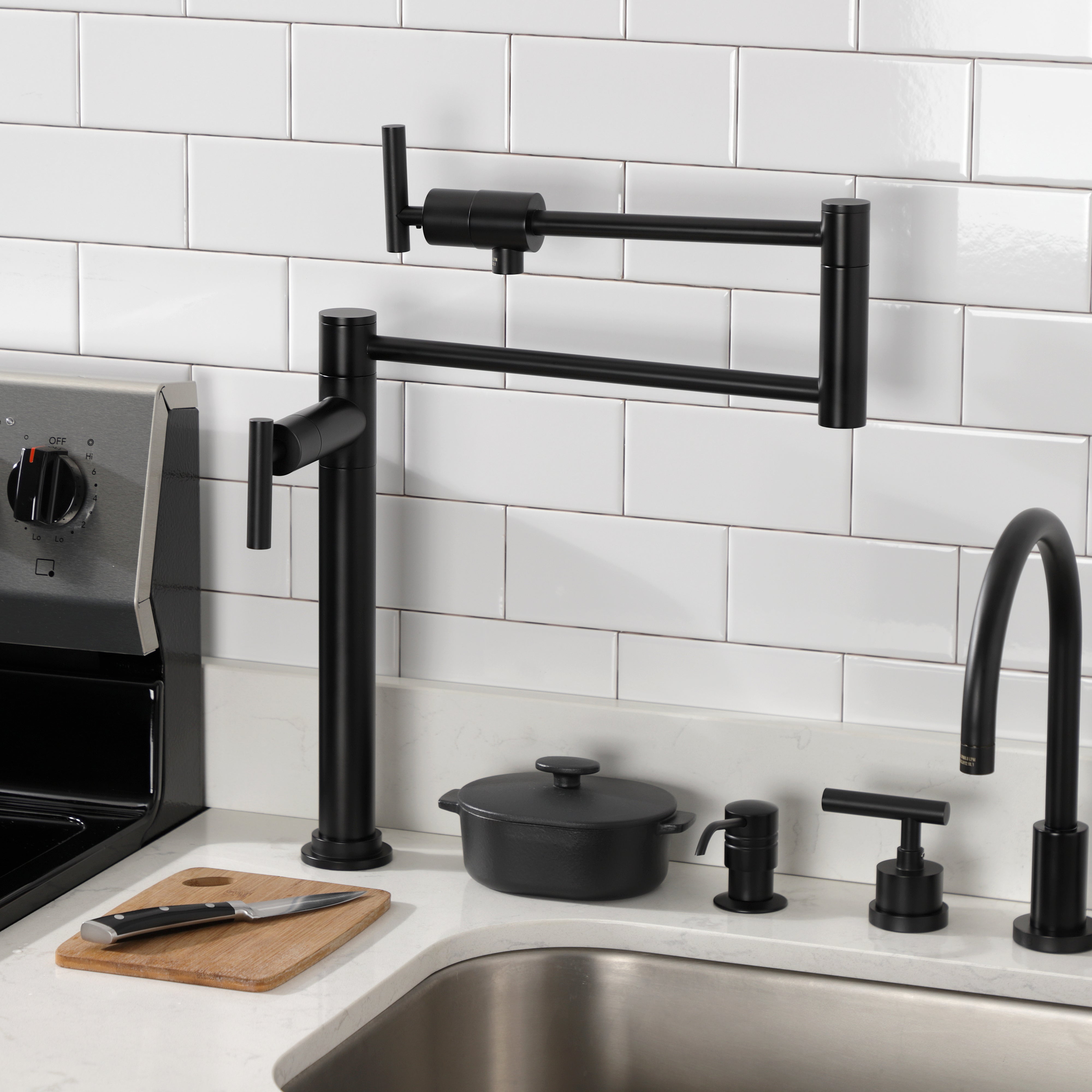 Kingston Brass KS4703CML Manhattan Deck Mount Pot Filler Faucet, Antique Brass installed in modern kitchen setting.
