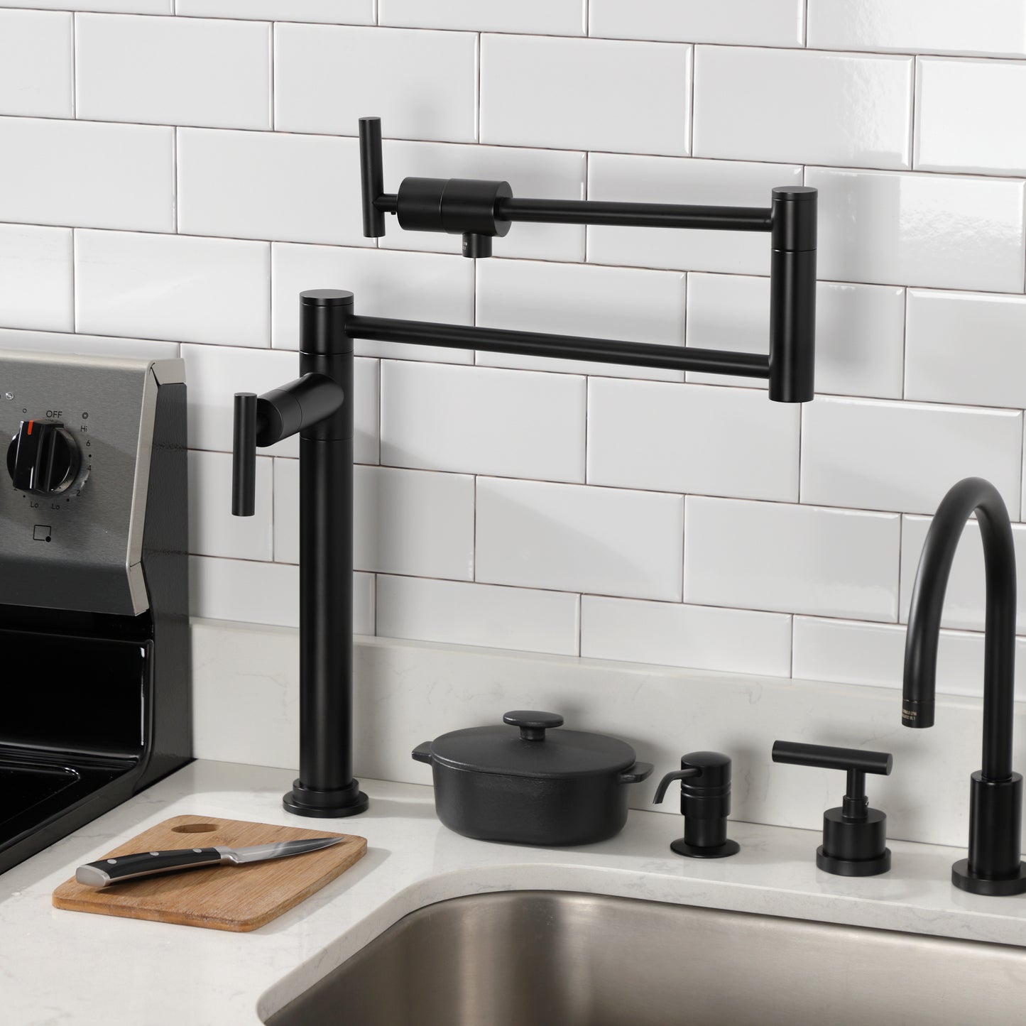 Kingston Brass KS4703CML Manhattan Deck Mount Pot Filler Faucet, Antique Brass installed in modern kitchen setting.