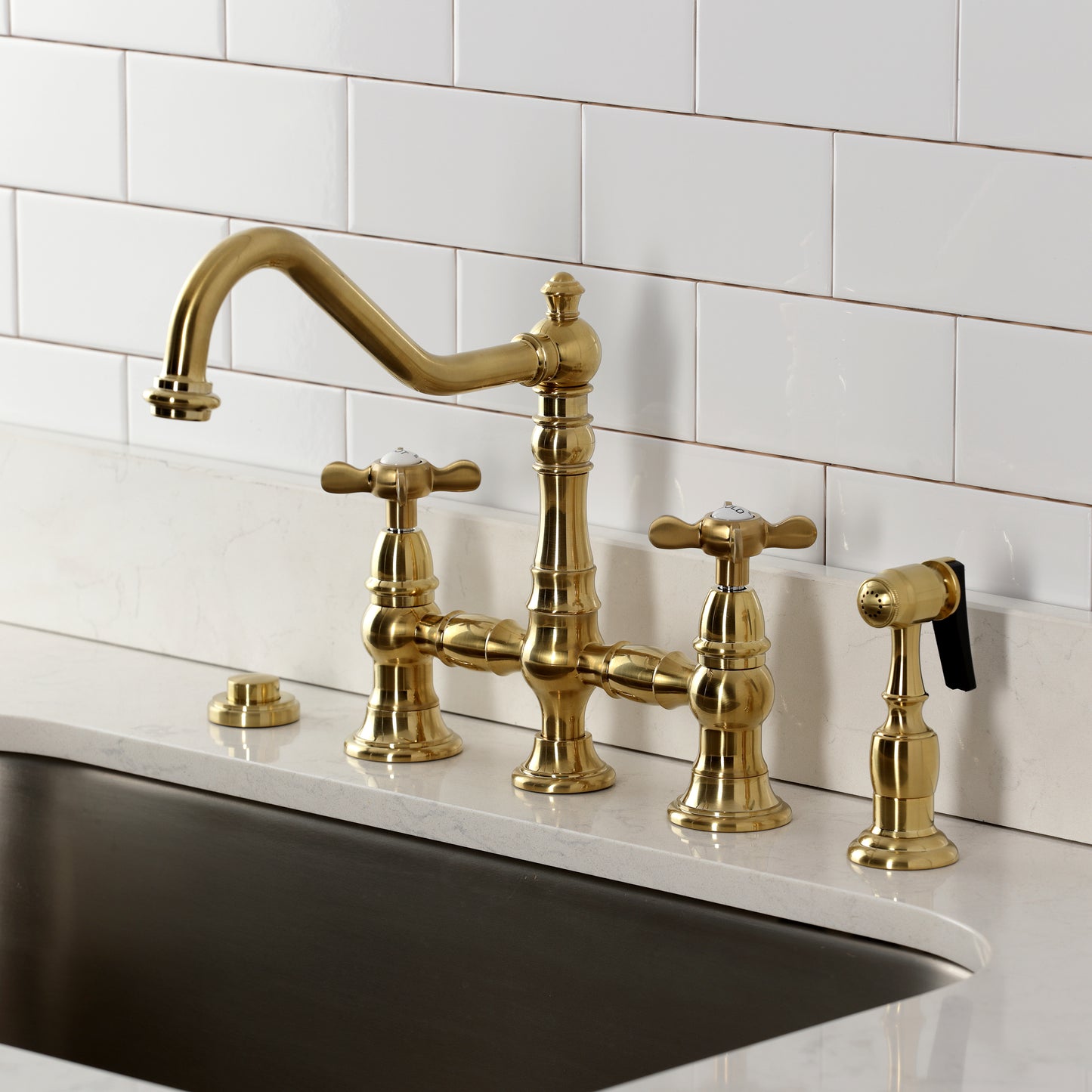 Kingston KS3277BEXBS Essex Bridge Kitchen Faucet with Brass Sprayer, Brushed Brass installed on countertop