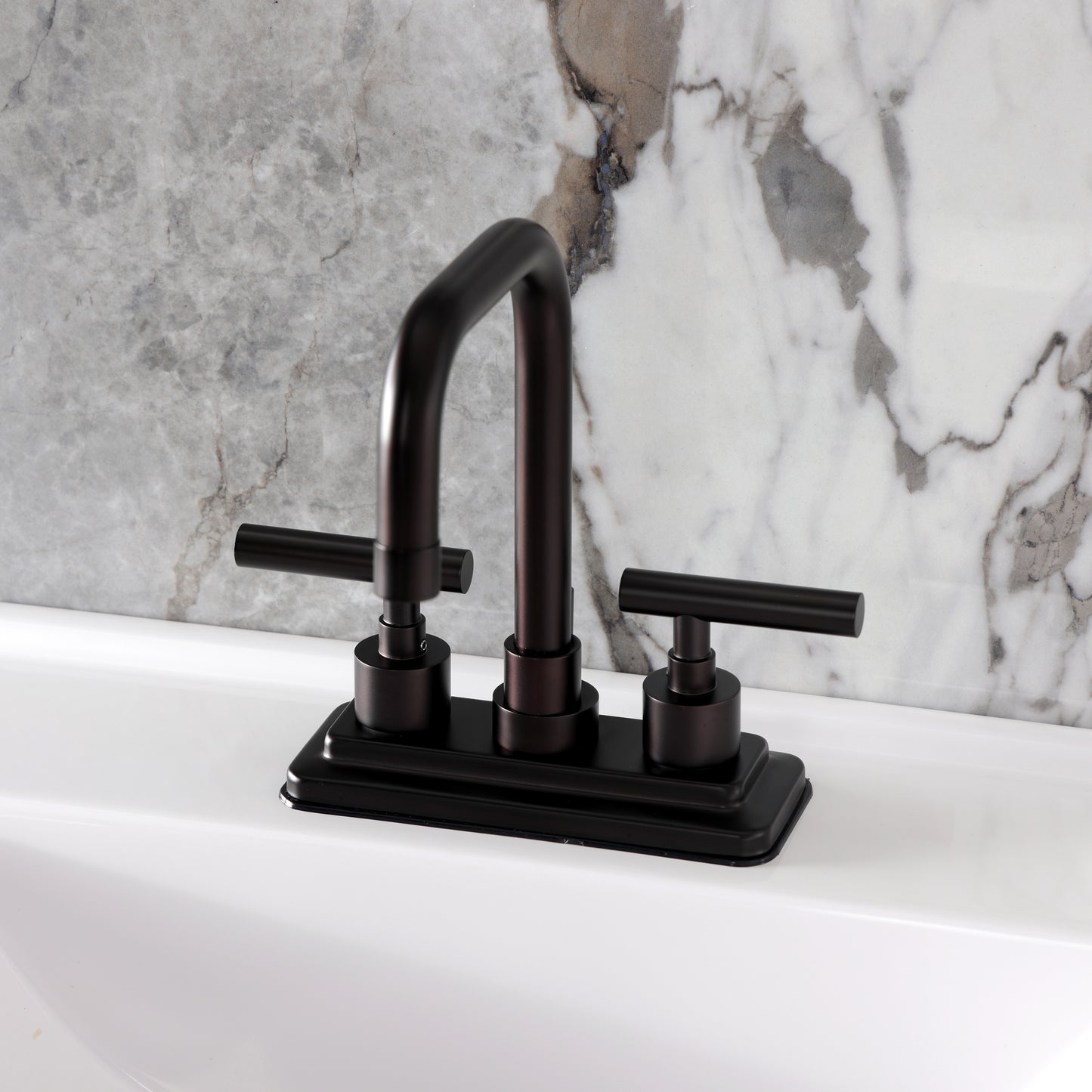 Kingston Brass KS6643CML Manhattan Centerset Bathroom Faucet top view on white sink with marble background.