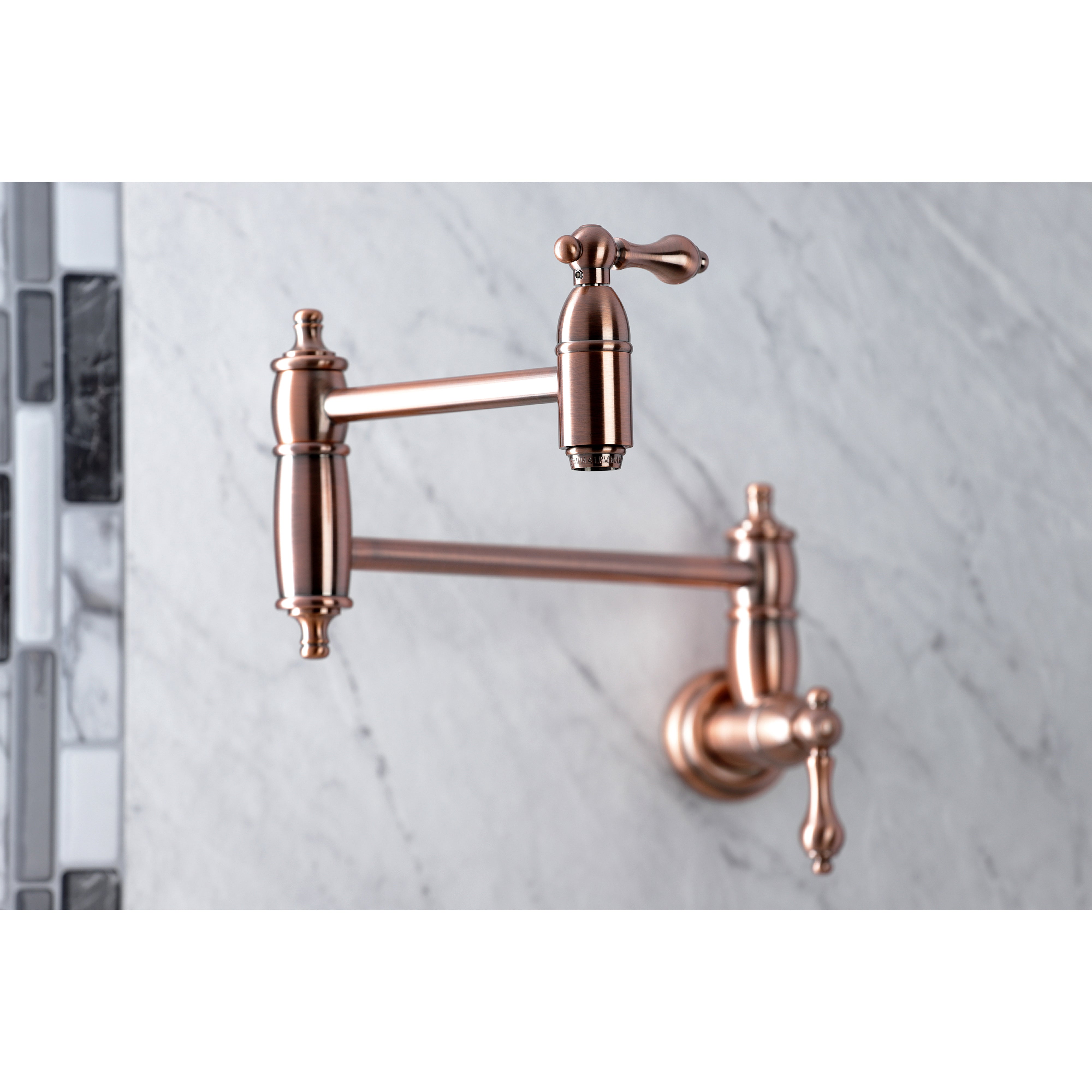 Kingston Brass KS3103AL Restoration Wall Mount Pot Filler Faucet, Antique Brass close-up on marble backsplash