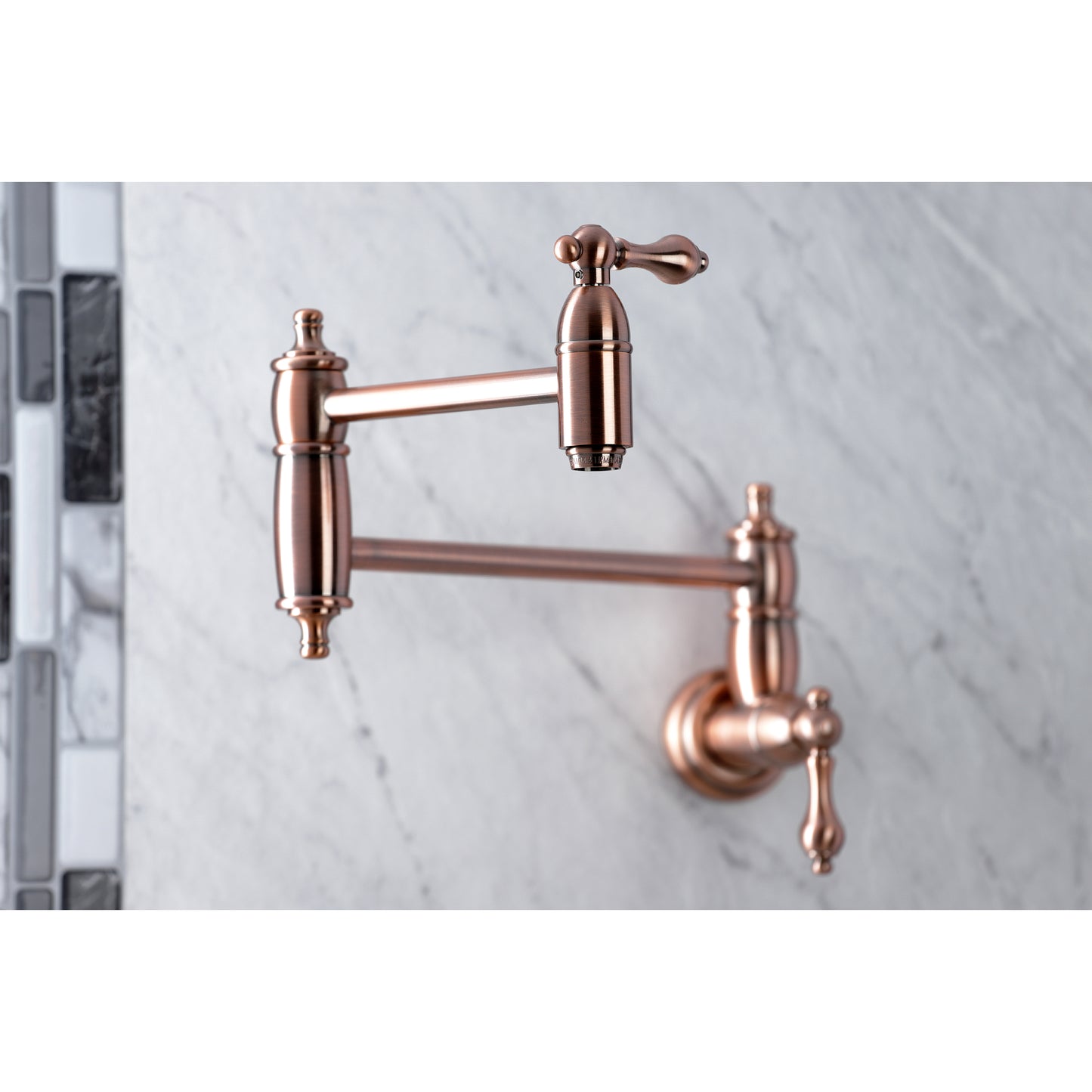 Kingston Brass KS3103AL Restoration Wall Mount Pot Filler Faucet, Antique Brass close-up on marble backsplash