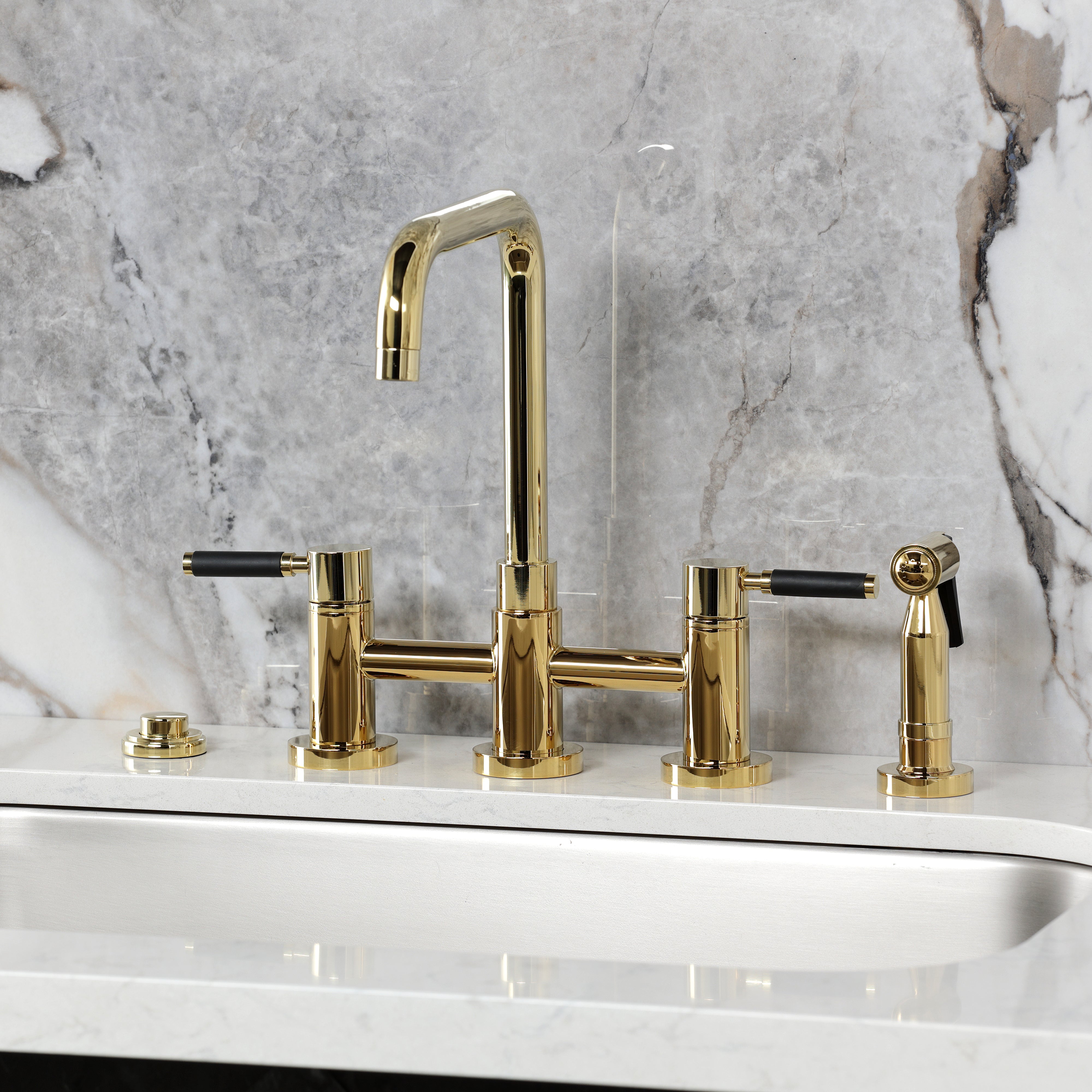 Kingston KS8287DKLBS Kaiser Bridge Kitchen Faucet with Brass Sprayer, Brushed Brass on a modern kitchen countertop.