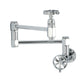 Kingston Brass KS5103RX Belknap Wall Mount Pot Filler Faucet, Antique Brass with industrial wheel handles and chrome finish.