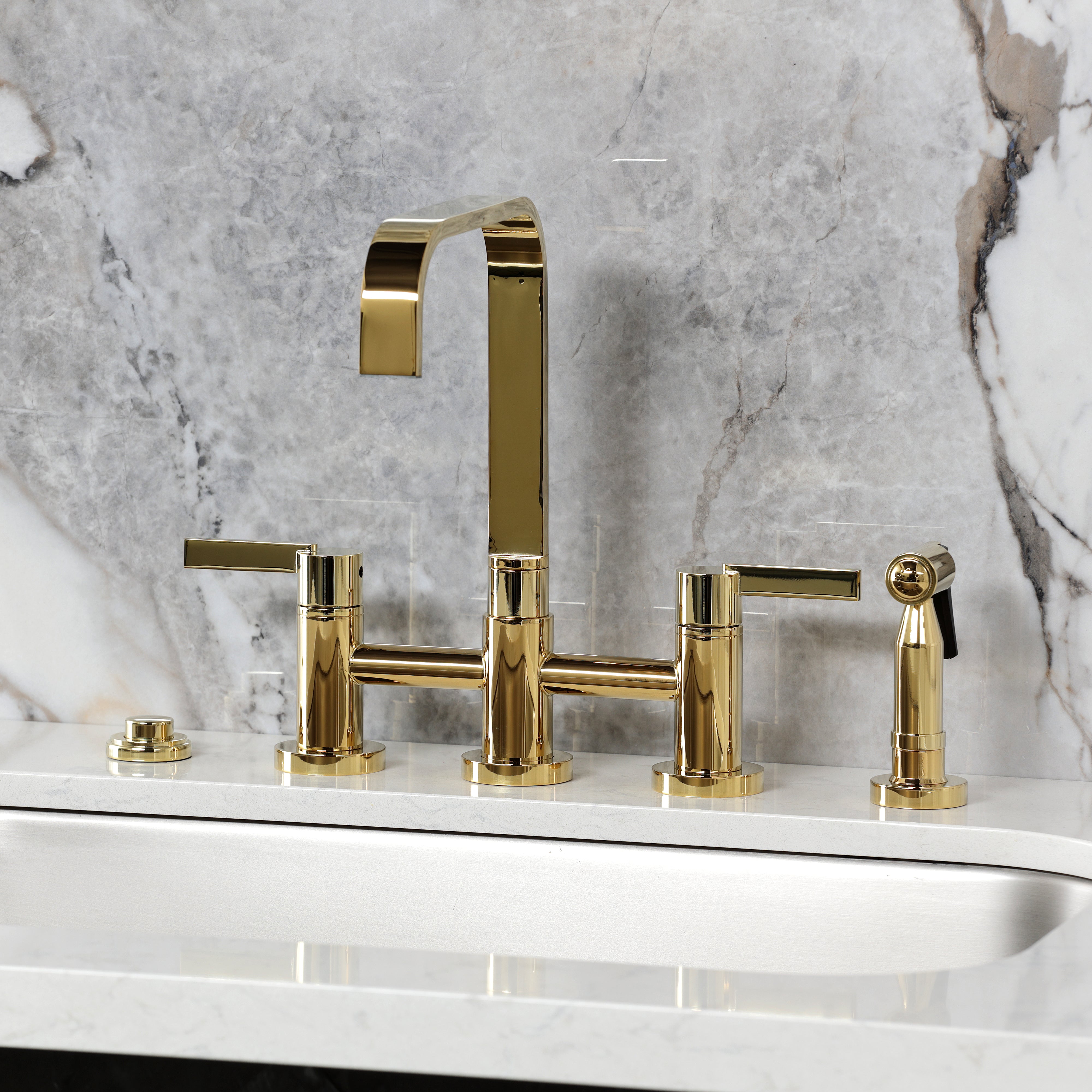 Kingston KS8257CTLBS Continental Bridge Kitchen Faucet with Brass Sprayer, Brushed Brass on a marble countertop.