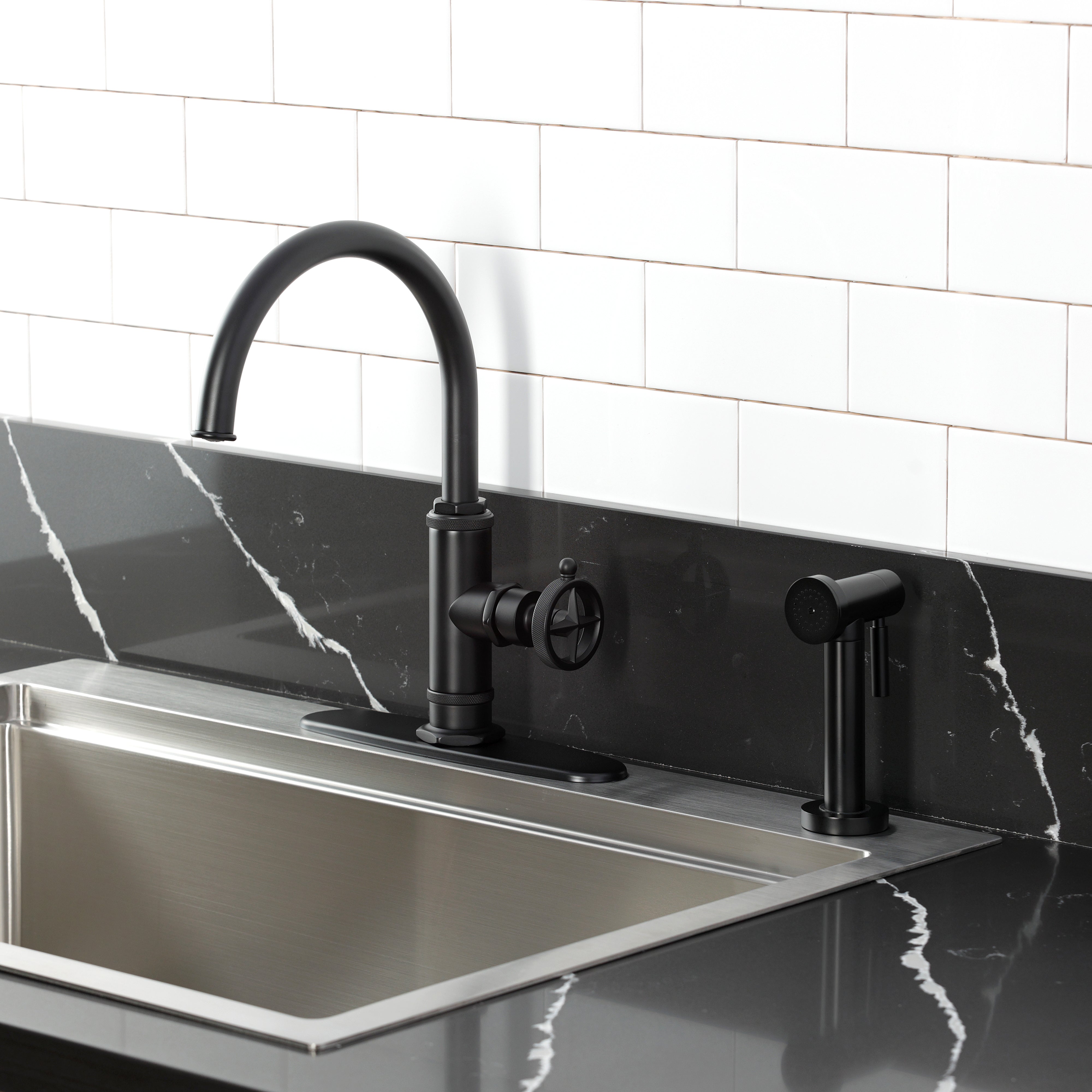 Kingston Brass KSD2433RNK Levante Single-Handle Kitchen Faucet, Antique Brass on black countertop with side spray.