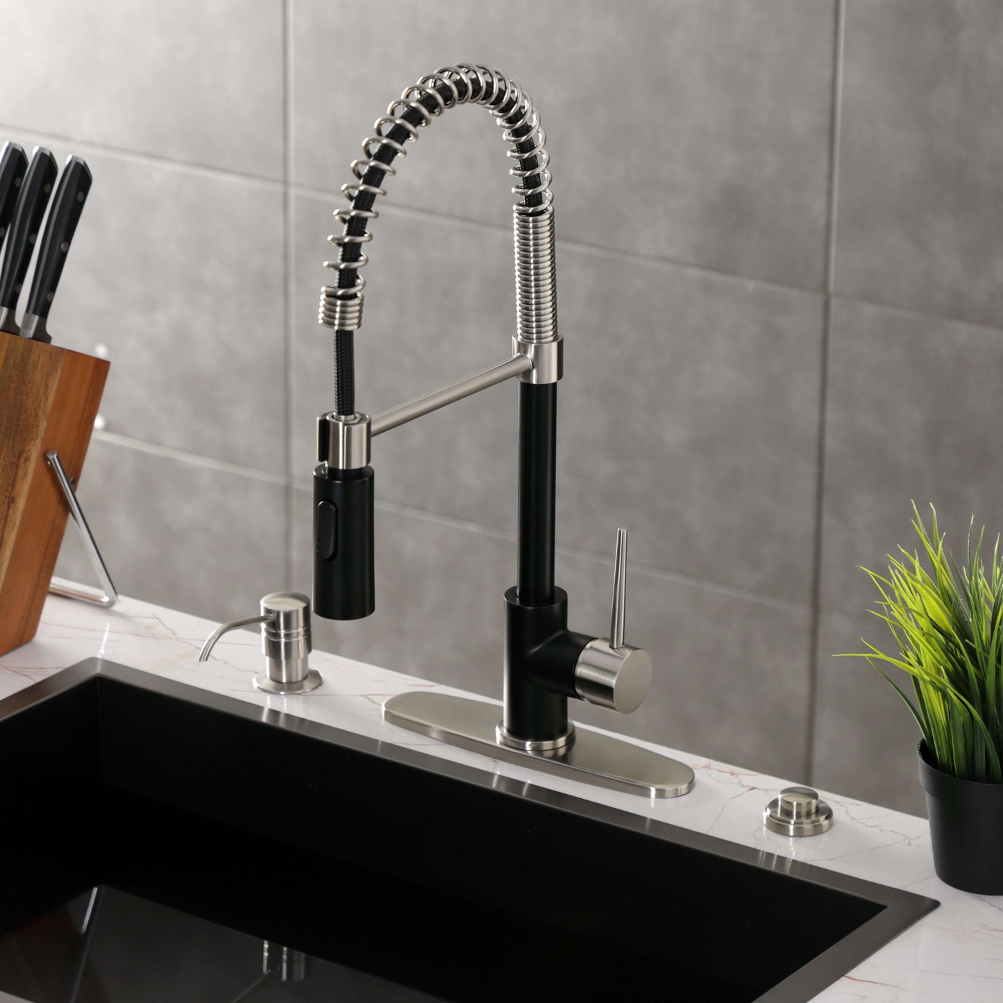 Kingston Brass LS8778NYL New York Pre-Rinse Kitchen Faucet in a kitchen setting with a black sink and cutting board.
