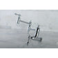 Kingston Brass KS3103AL Restoration Wall Mount Pot Filler Faucet, Antique Brass on a marble countertop.