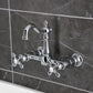 Kingston KS2443AX Heritage Two-Handle Wall Mount Bridge Kitchen Faucet, Antique Brass on a modern gray background