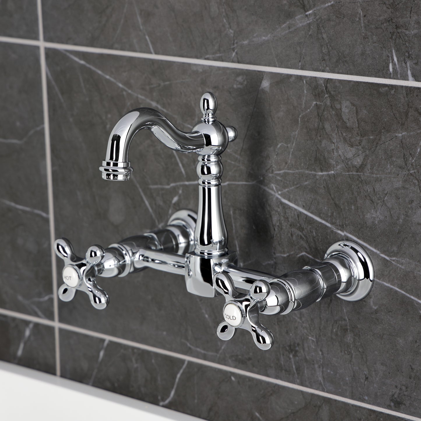 Kingston KS2443AX Heritage Two-Handle Wall Mount Bridge Kitchen Faucet, Antique Brass on a modern gray background