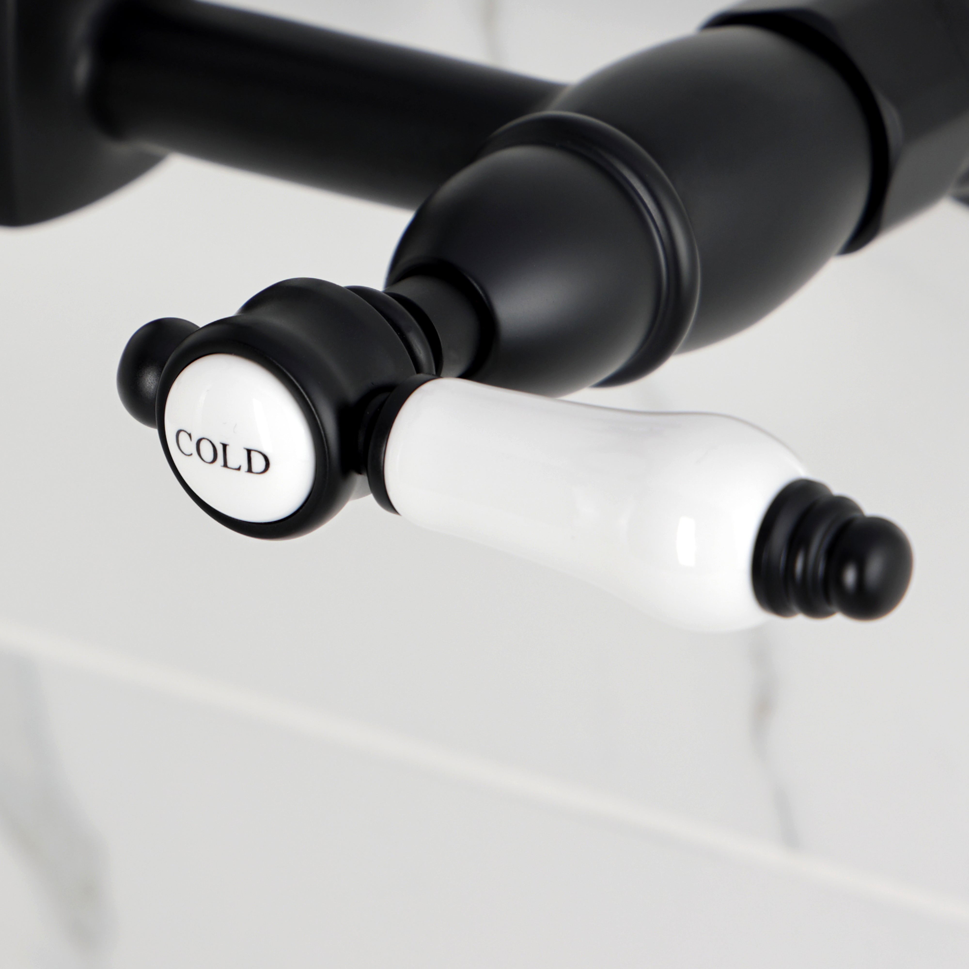 Kingston KS2443BPL Bel-Air Two-Handle Wall Mount Bridge Kitchen Faucet, Antique Brass cold handle close-up