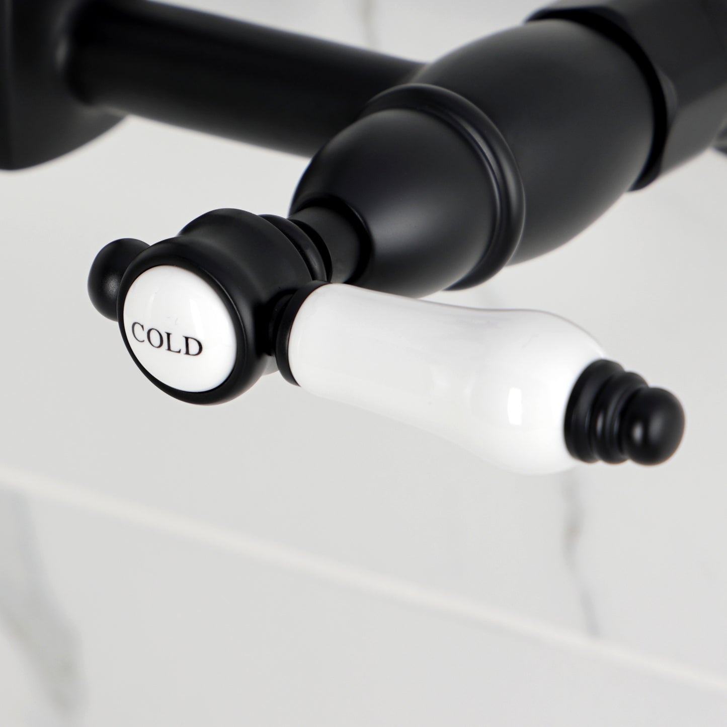 Kingston KS2443BPL Bel-Air Two-Handle Wall Mount Bridge Kitchen Faucet, Antique Brass cold handle close-up