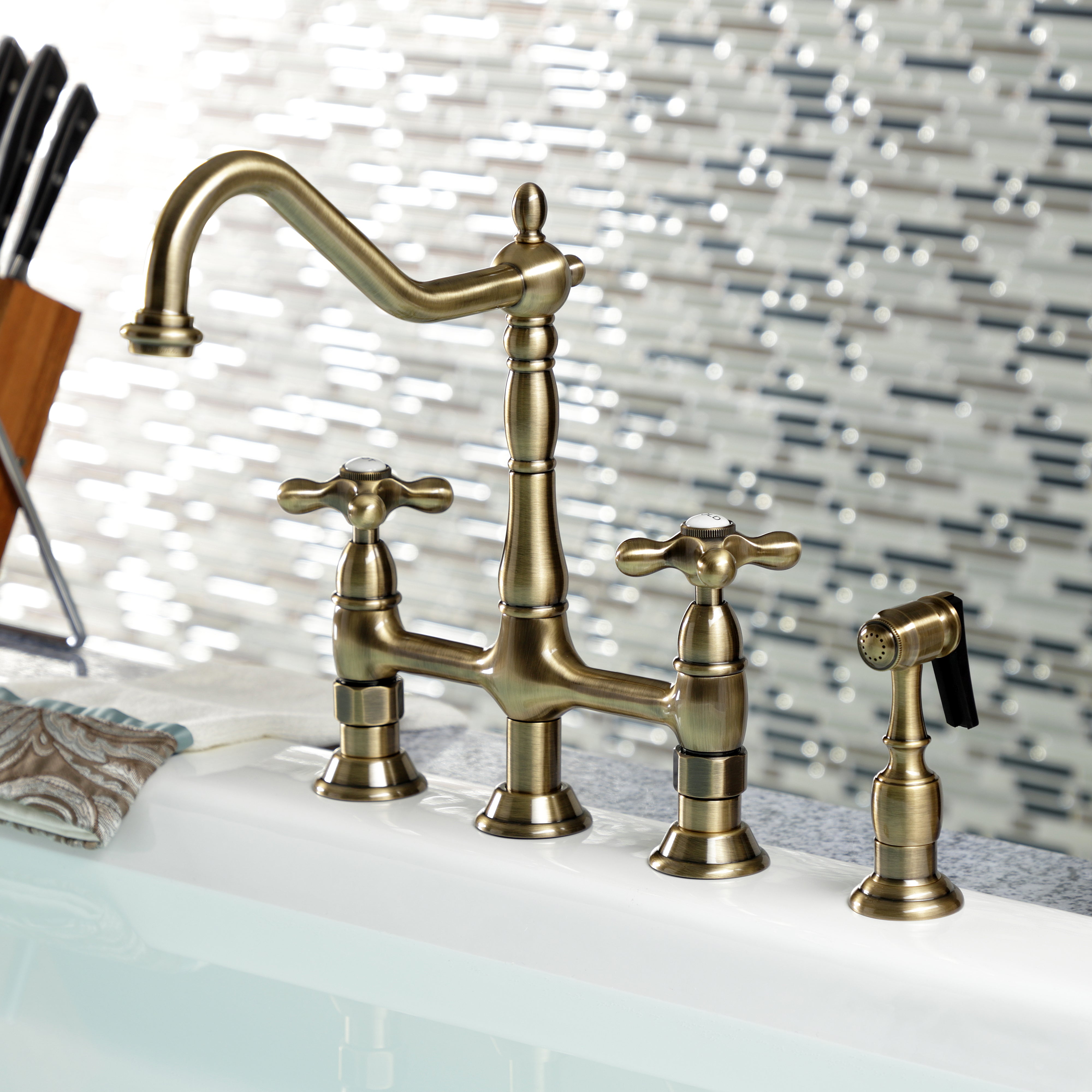 Kingston KS1273AXBS Heritage Bridge Kitchen Faucet with Brass Sprayer, Antique Brass on white countertop