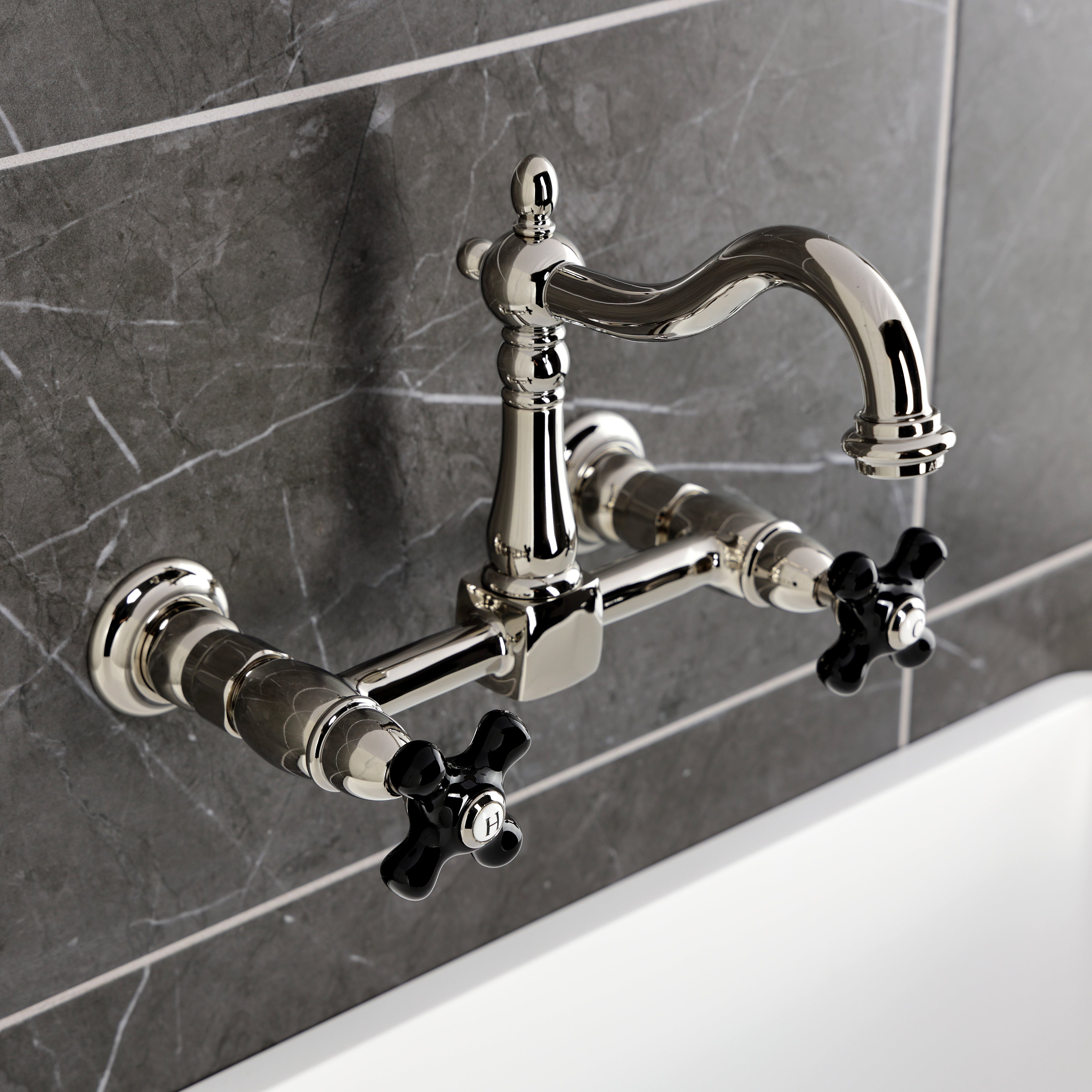 Kingston KS1263PKX Duchess Two-Handle Wall Mount Bridge Kitchen Faucet, Antique Brass with black porcelain handles