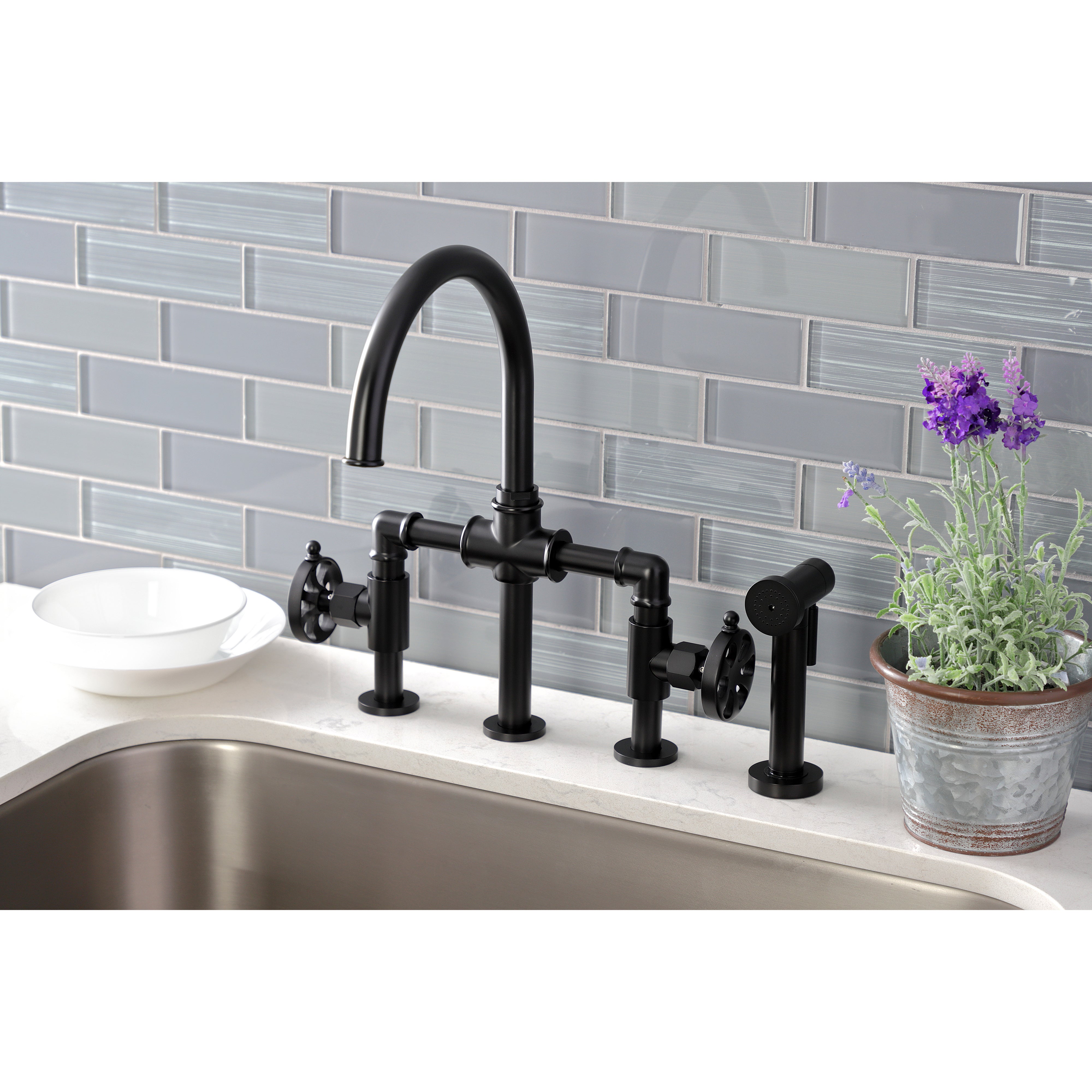 Kingston KS2333RX Belknap Industrial Style Bridge Kitchen Faucet with Brass Sprayer, Antique Brass in a modern kitchen setting.
