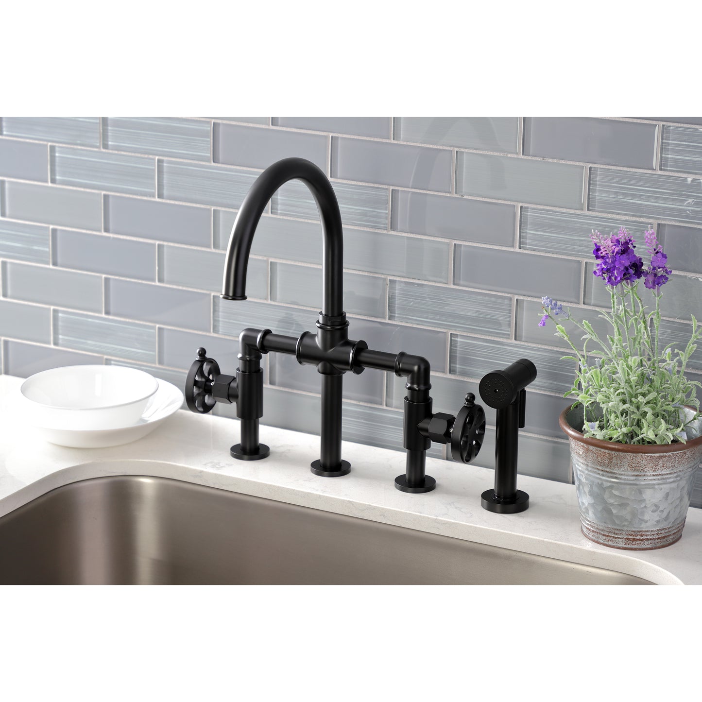 Kingston KS2333RX Belknap Industrial Style Bridge Kitchen Faucet with Brass Sprayer, Antique Brass in a modern kitchen setting.