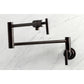 Kingston Brass KS4103CML Manhattan Wall Mount Pot Filler Faucet, Antique Brass on a marble background.