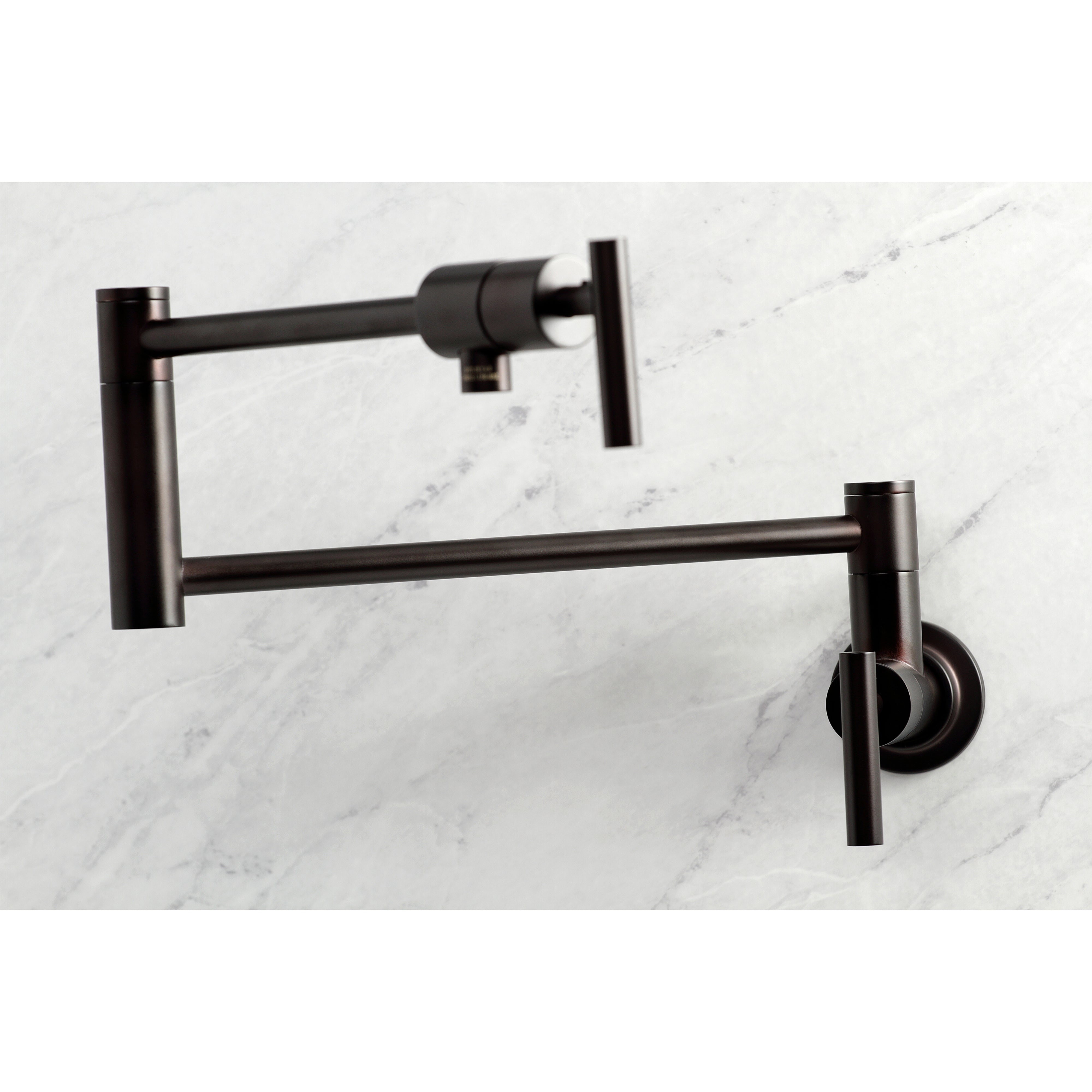 Kingston Brass KS4103CML Manhattan Wall Mount Pot Filler Faucet, Antique Brass on a marble background.