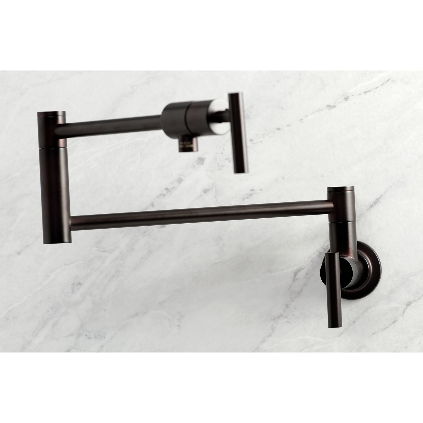 Kingston Brass KS4103CML Manhattan Wall Mount Pot Filler Faucet, Antique Brass on a marble background.