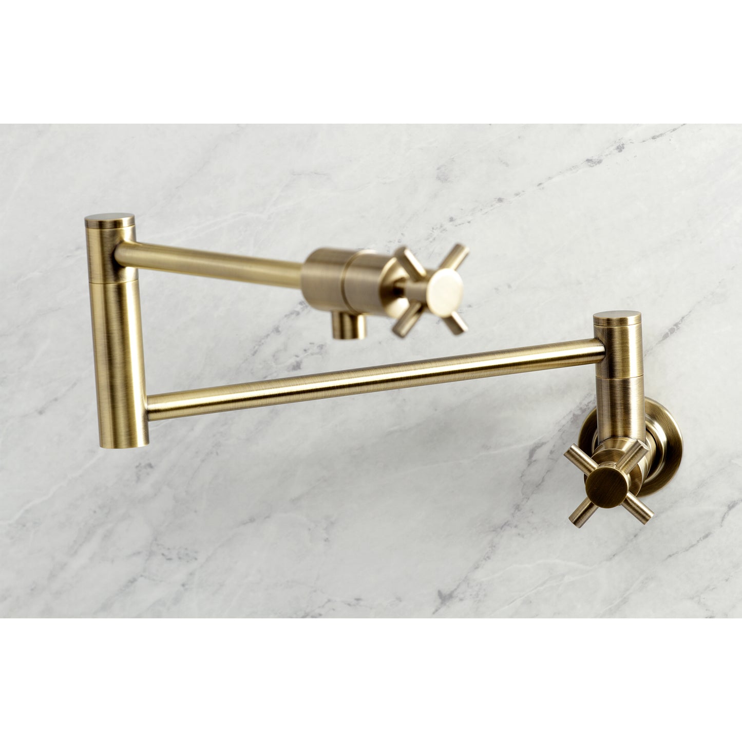 Kingston Brass KS4103DX Concord Wall Mount Pot Filler Faucet, Antique Brass on marble background.