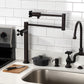 Kingston Brass KS4703PKX Duchess Deck Mount Pot Filler Faucet, Antique Brass in kitchen setting with black porcelain handles.