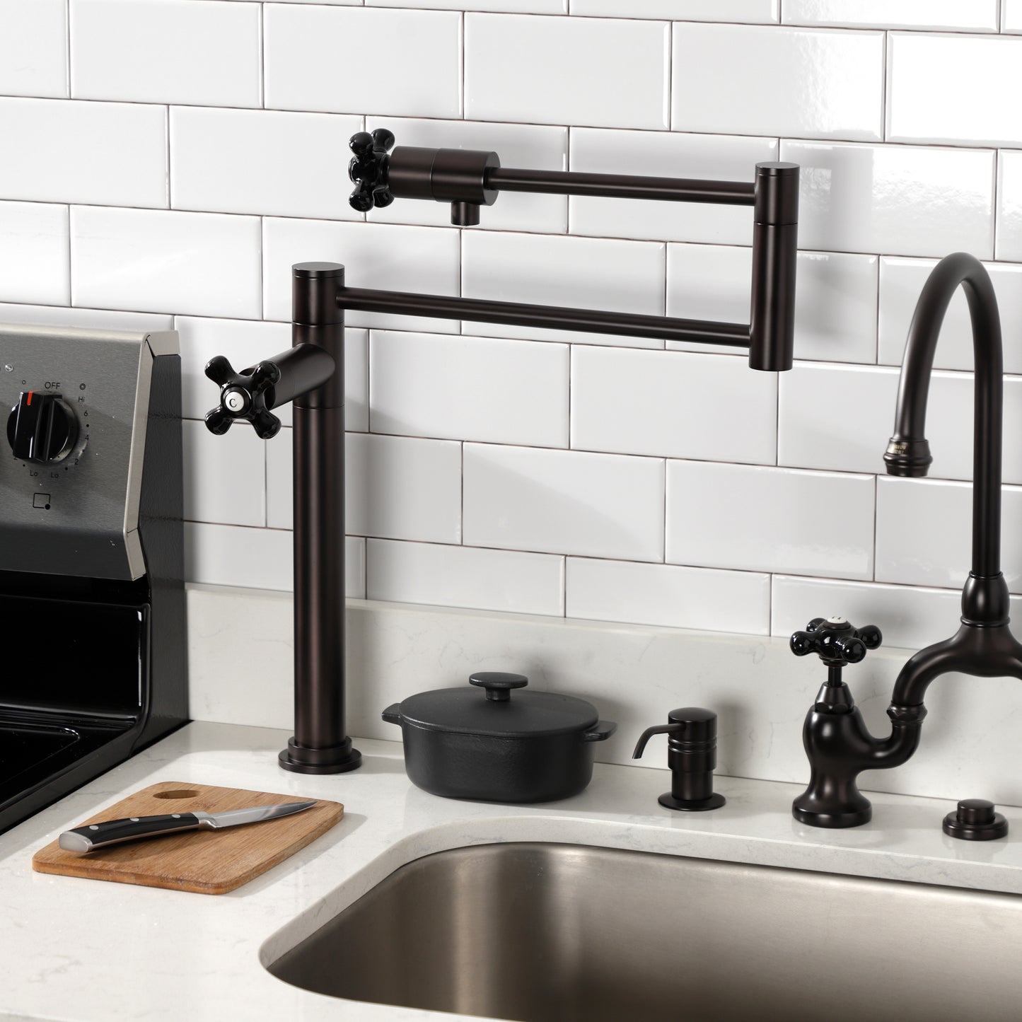Kingston Brass KS4703PKX Duchess Deck Mount Pot Filler Faucet, Antique Brass in kitchen setting with black porcelain handles.