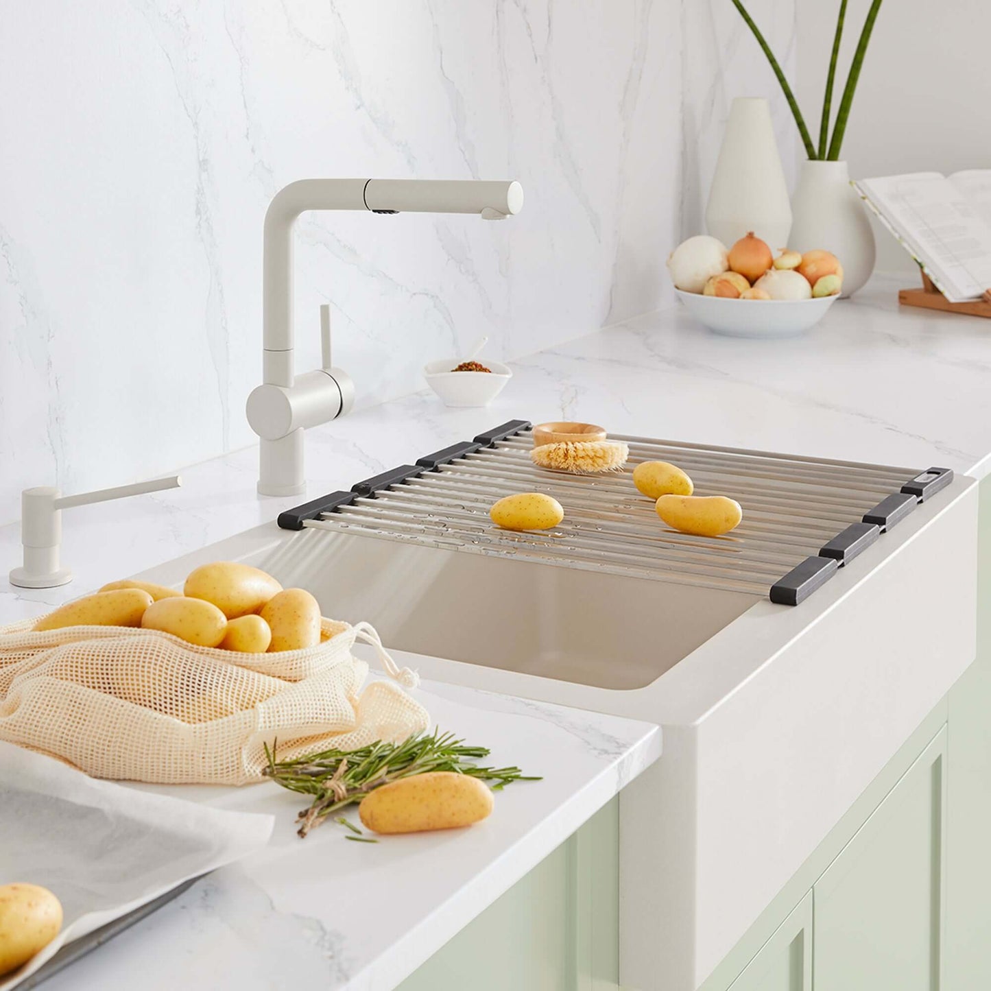 BLANCO Linus Low Arc Pull-Out Dual-Spray Kitchen Faucet - Soft White in modern kitchen with fresh potatoes on sink.
