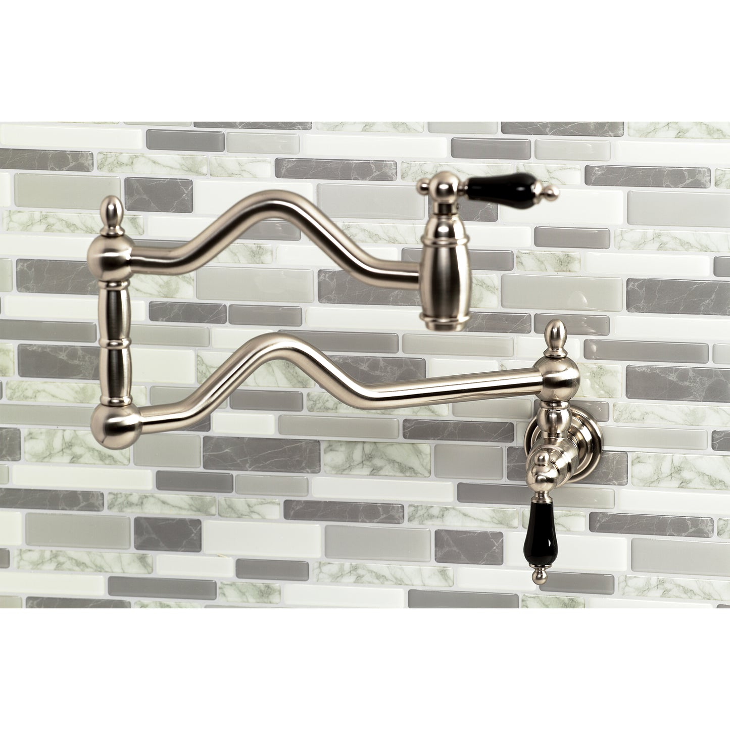Kingston Brass KS2107PKL Duchess Wall Mount Pot Filler Faucet, Brushed Brass with black porcelain handles.