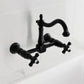 Kingston KS1263PKX Duchess Two-Handle Wall Mount Bridge Kitchen Faucet, Antique Brass with black porcelain handles.