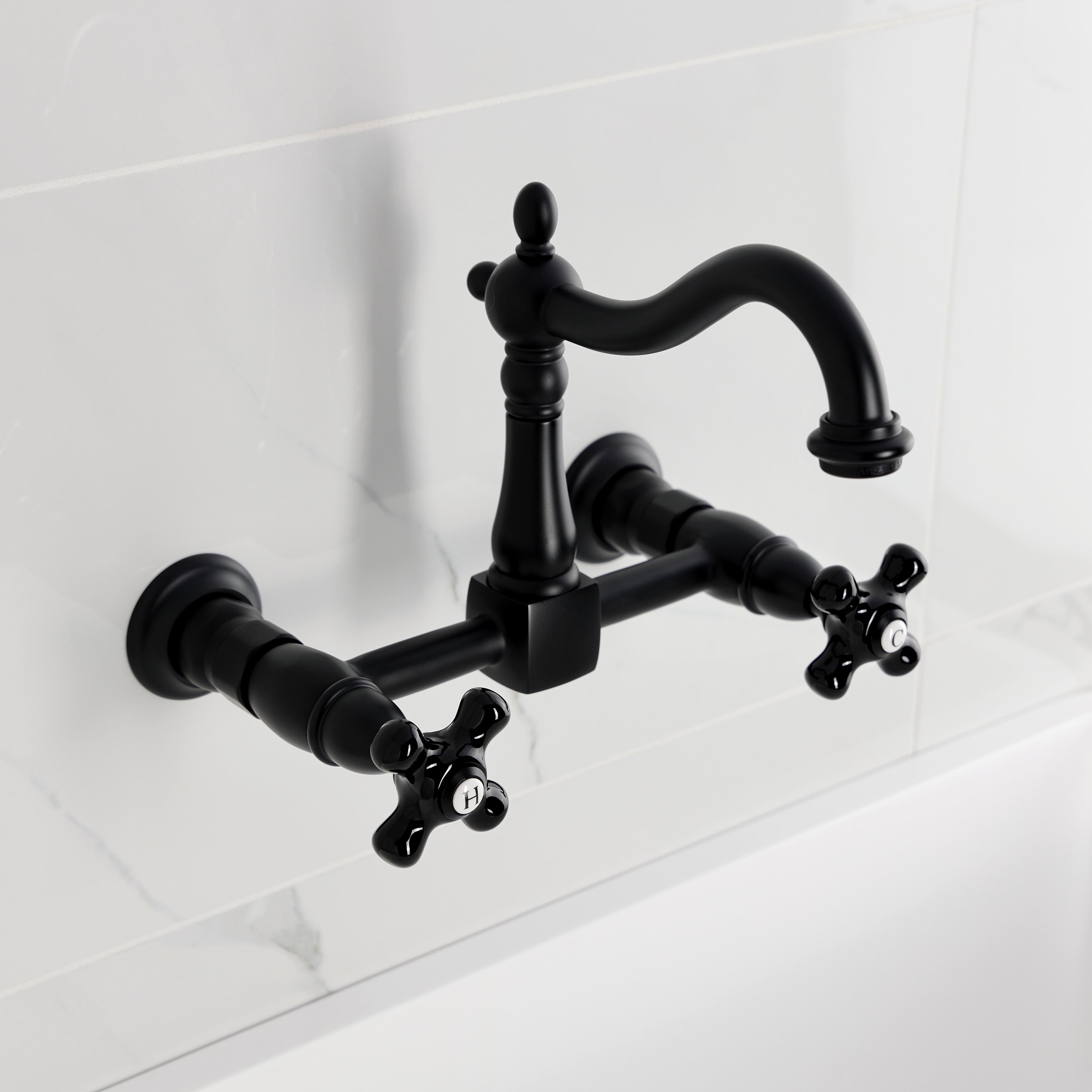 Kingston KS1263PKX Duchess Two-Handle Wall Mount Bridge Kitchen Faucet, Antique Brass with black porcelain handles.