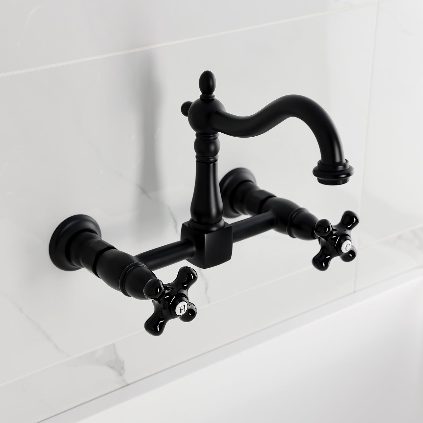 Kingston KS1263PKX Duchess Two-Handle Wall Mount Bridge Kitchen Faucet, Antique Brass with black porcelain handles.