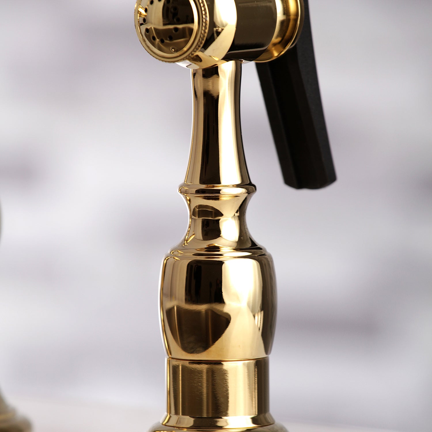 Kingston KS3277PXBS Restoration Bridge Kitchen Faucet with Brass Sprayer, Brushed Brass close-up of brass sprayer handle