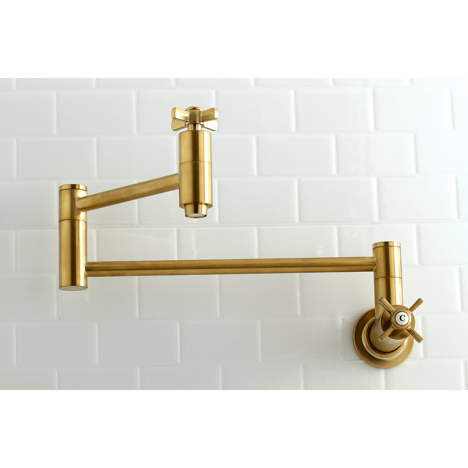 Kingston Brass KS8103ZX Millennium Wall Mount Pot Filler Faucet, Antique Brass on a white tiled wall.