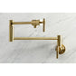 Kingston Brass KS4103ML Milano Wall Mount Pot Filler Faucet, Antique Brass on a marble background.