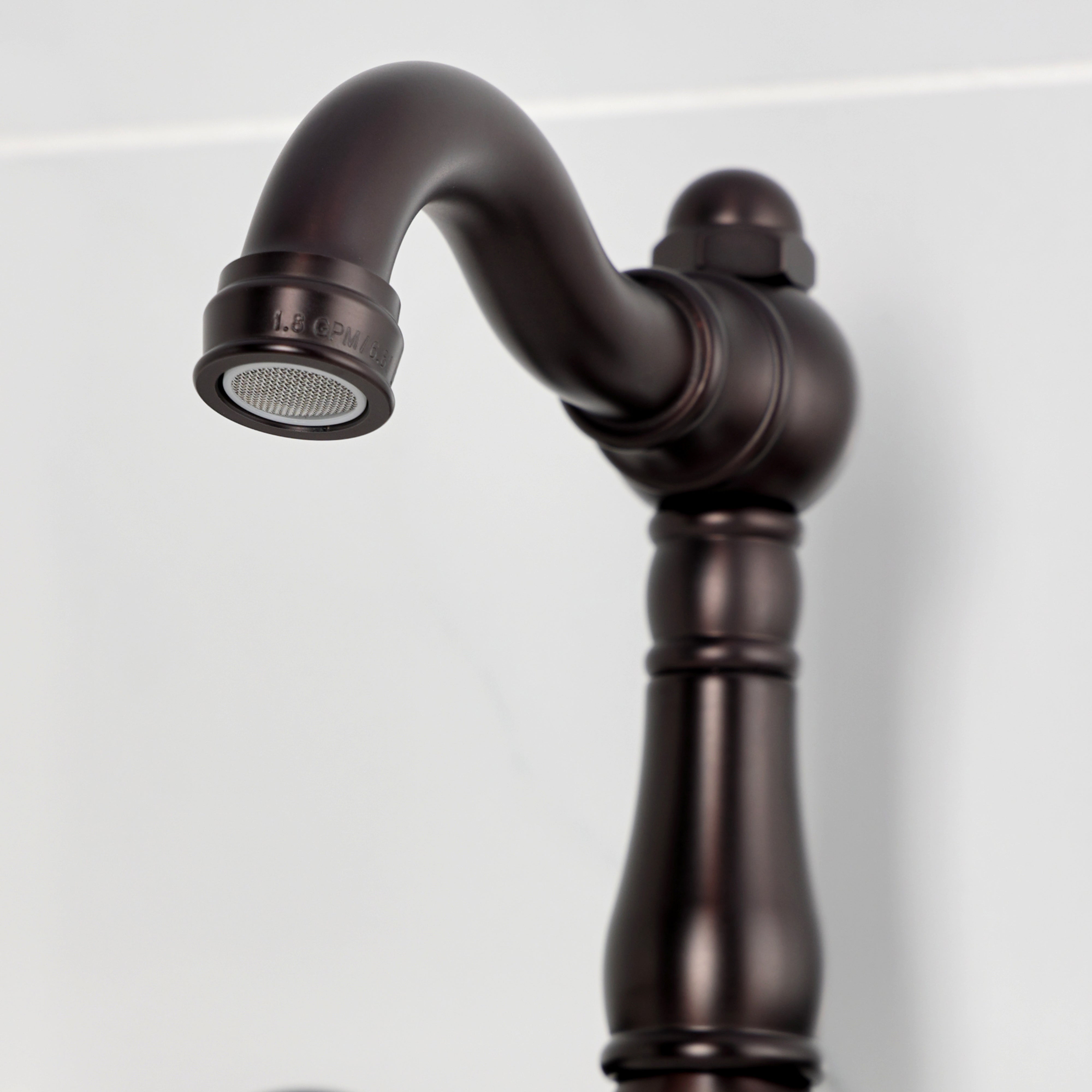 Kingston KS3253BEX Essex Two-Handle Wall Mount Bridge Kitchen Faucet, Antique Brass close-up of spout