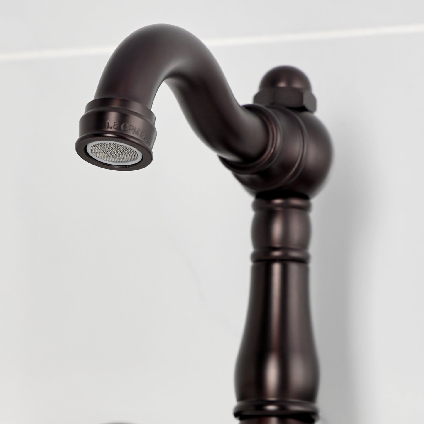 Kingston KS3253BEX Essex Two-Handle Wall Mount Bridge Kitchen Faucet, Antique Brass close-up of spout