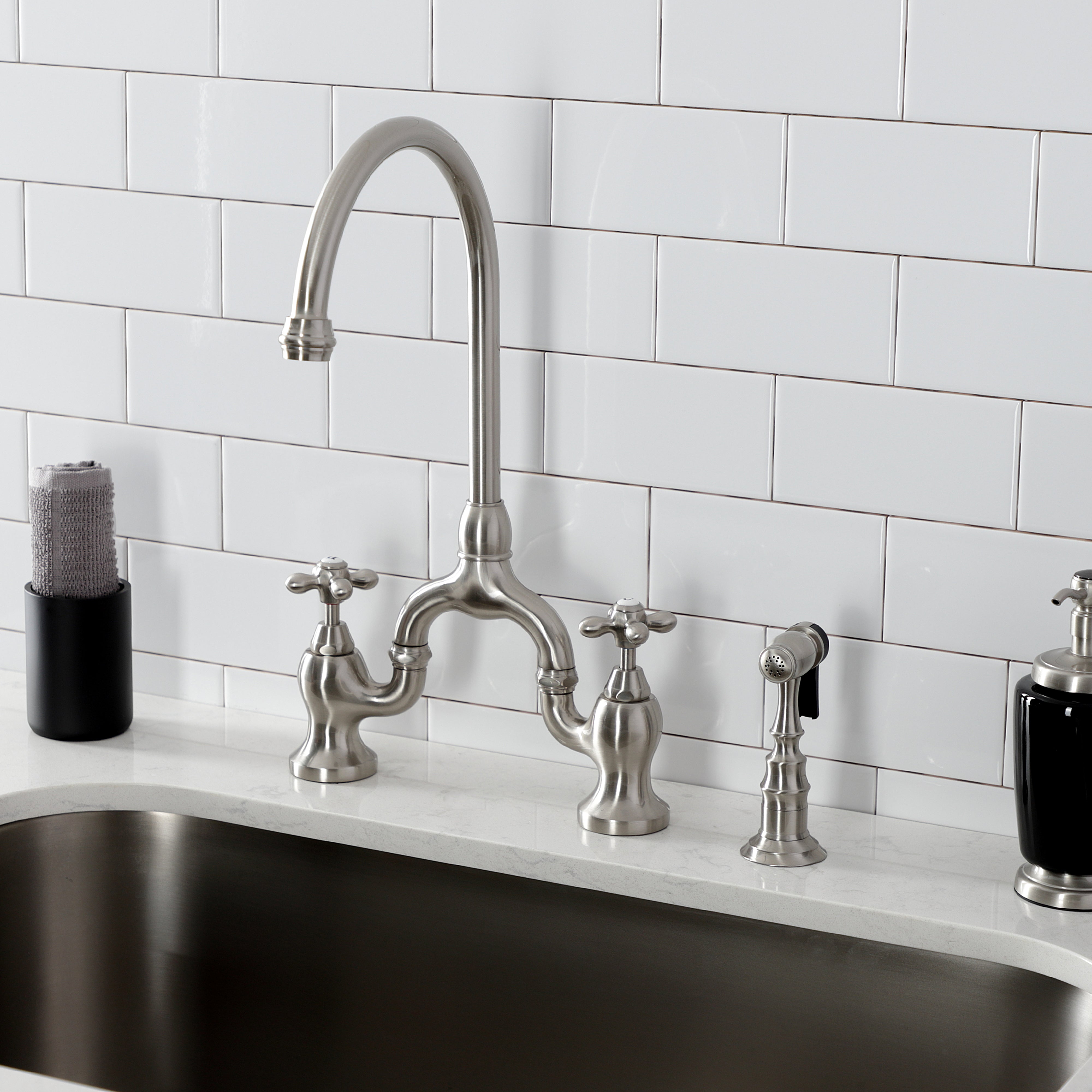 Kingston KS7793AXBS English Country Bridge Kitchen Faucet with Brass Sprayer, Antique Brass in a modern kitchen setting.
