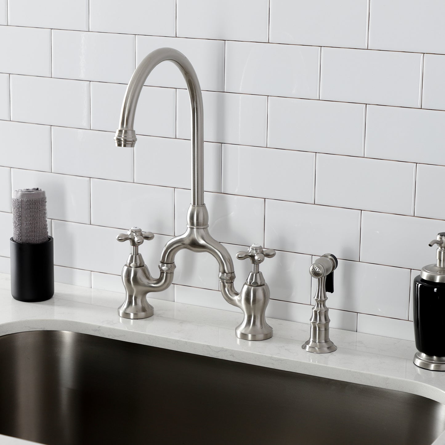 Kingston KS7793AXBS English Country Bridge Kitchen Faucet with Brass Sprayer, Antique Brass in a modern kitchen setting.