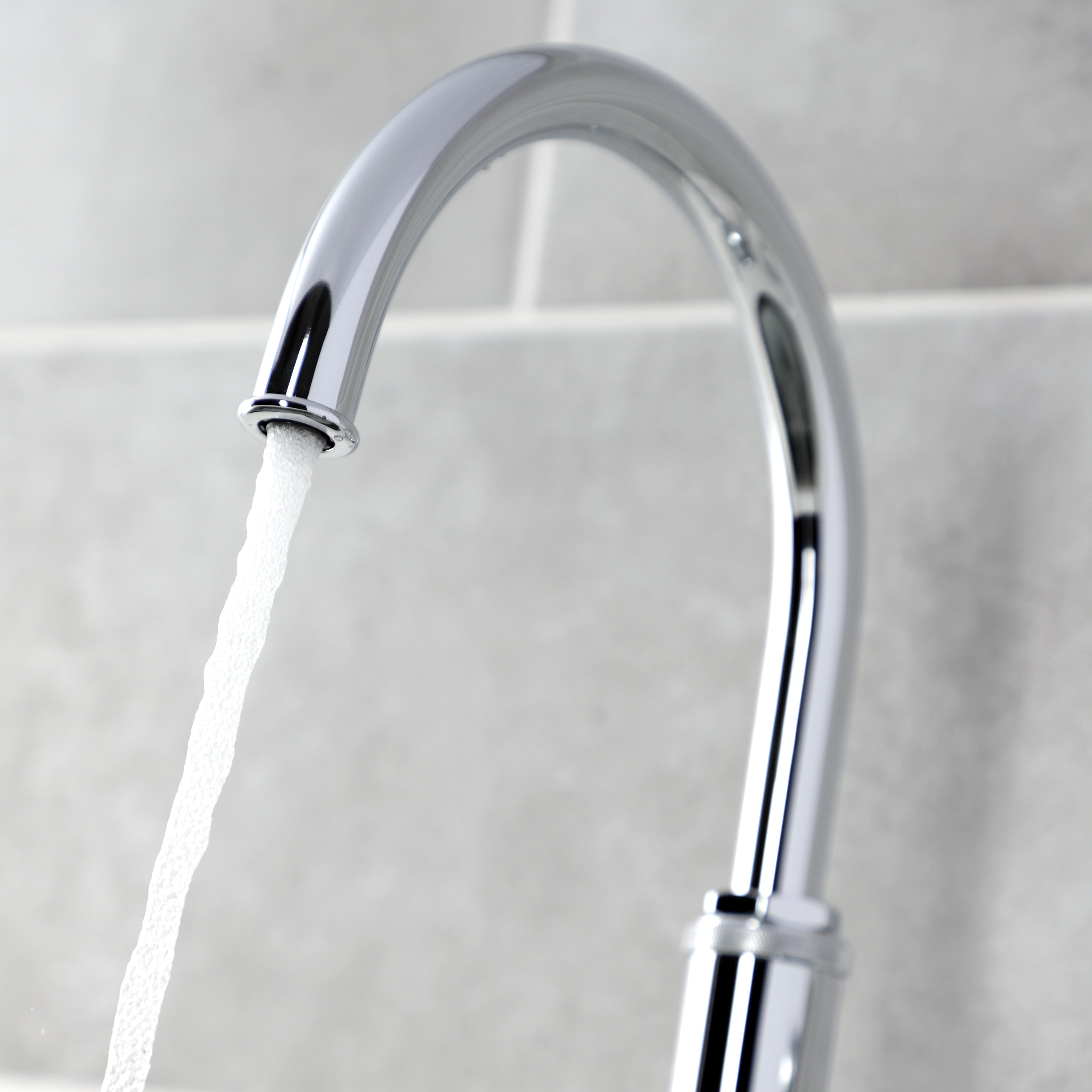 Kingston Brass KS2433KL Whitaker Single-Handle Kitchen Faucet with Brass Side Sprayer, Antique Brass - faucet spout in action.
