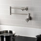 Kingston Brass KS4103CG Fuller Wall Mount Pot Filler Faucet, Antique Brass in a modern kitchen setting.