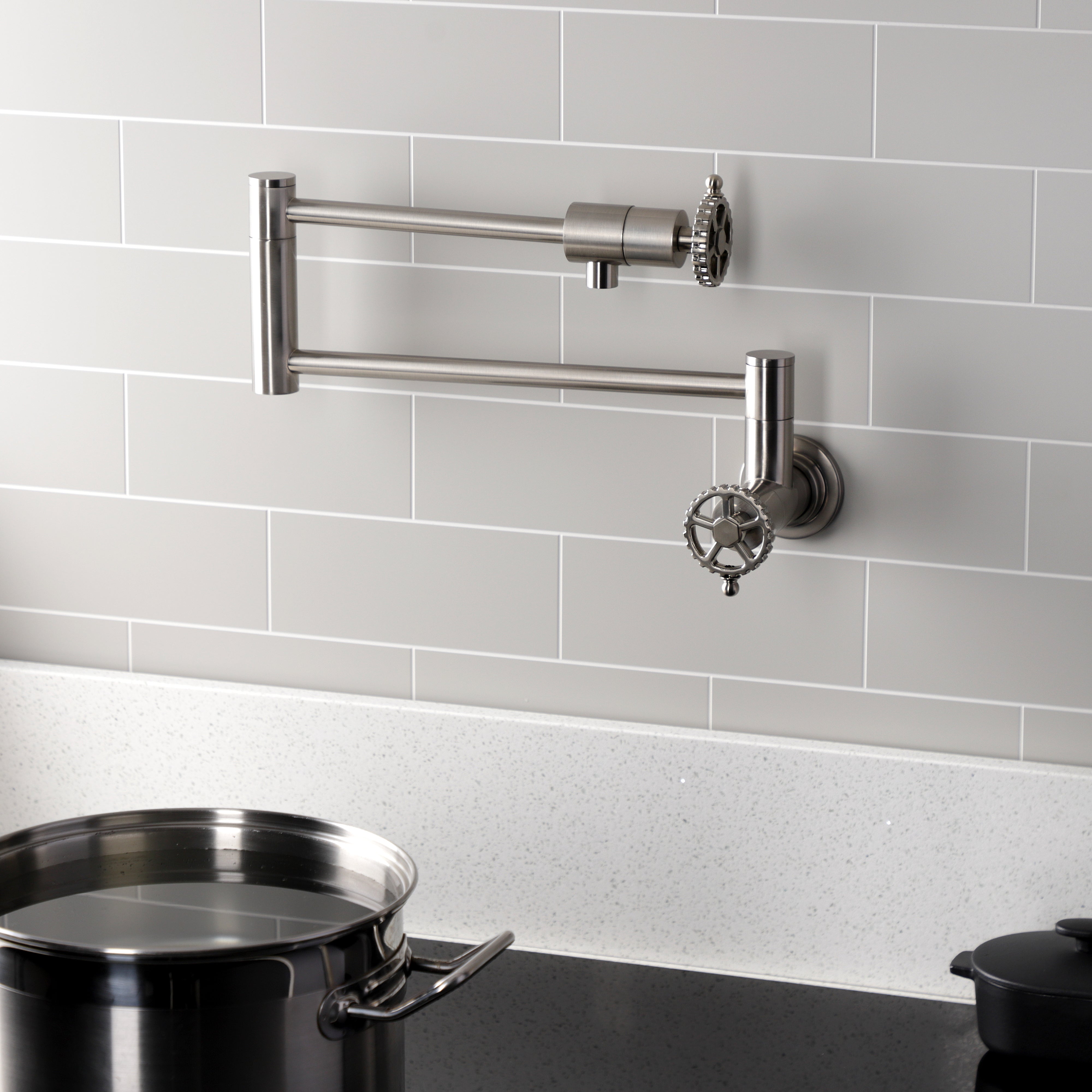 Kingston Brass KS4103CG Fuller Wall Mount Pot Filler Faucet, Antique Brass in a modern kitchen setting.