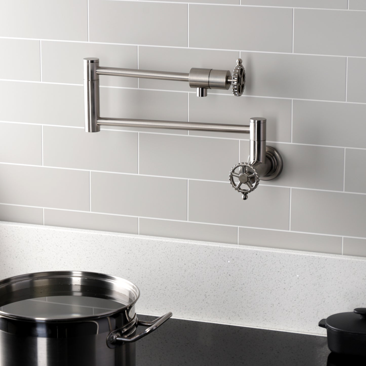 Kingston Brass KS4103CG Fuller Wall Mount Pot Filler Faucet, Antique Brass in a modern kitchen setting.