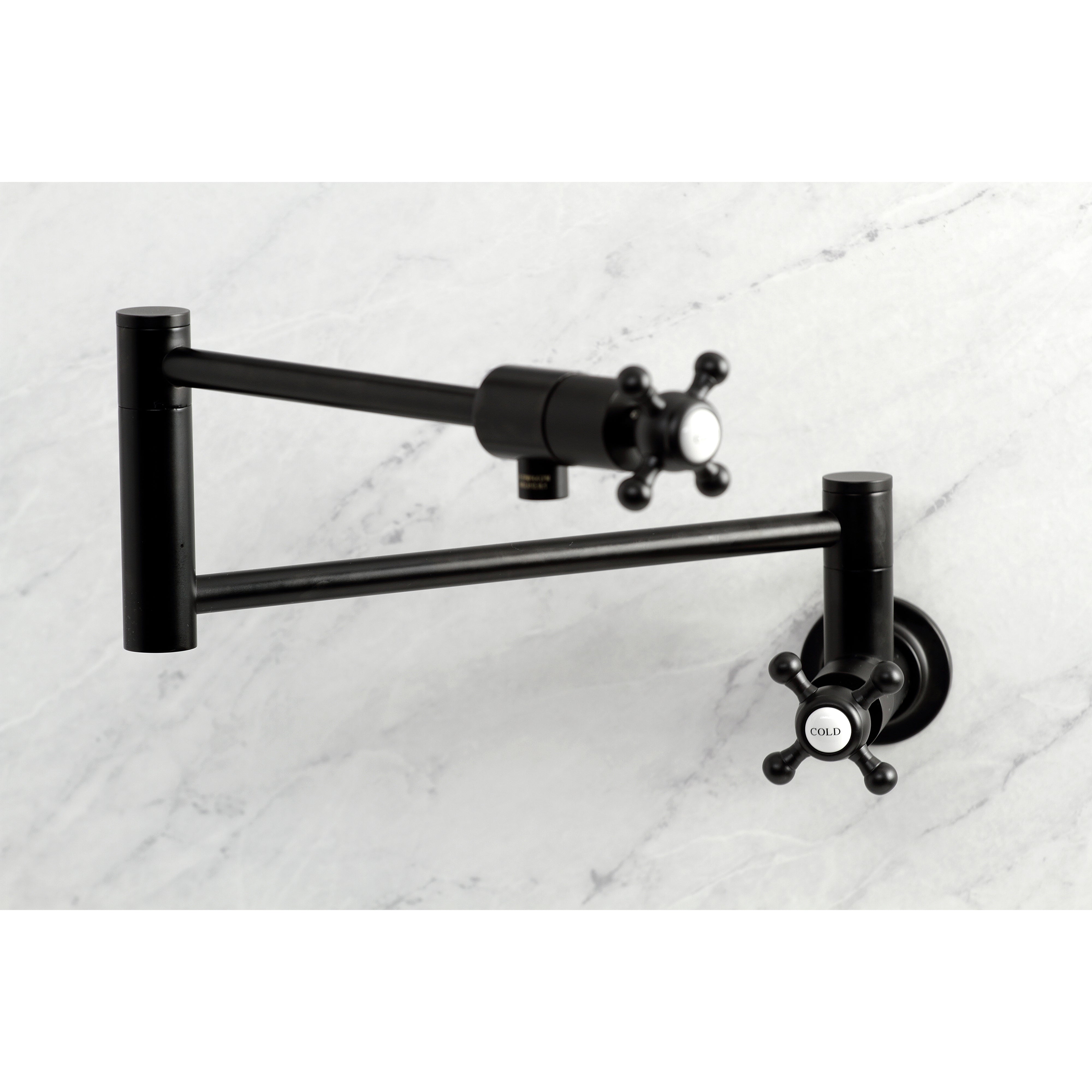 Kingston Brass KS4103BX Metropolitan Wall Mount Pot Filler Faucet, Antique Brass on marble background