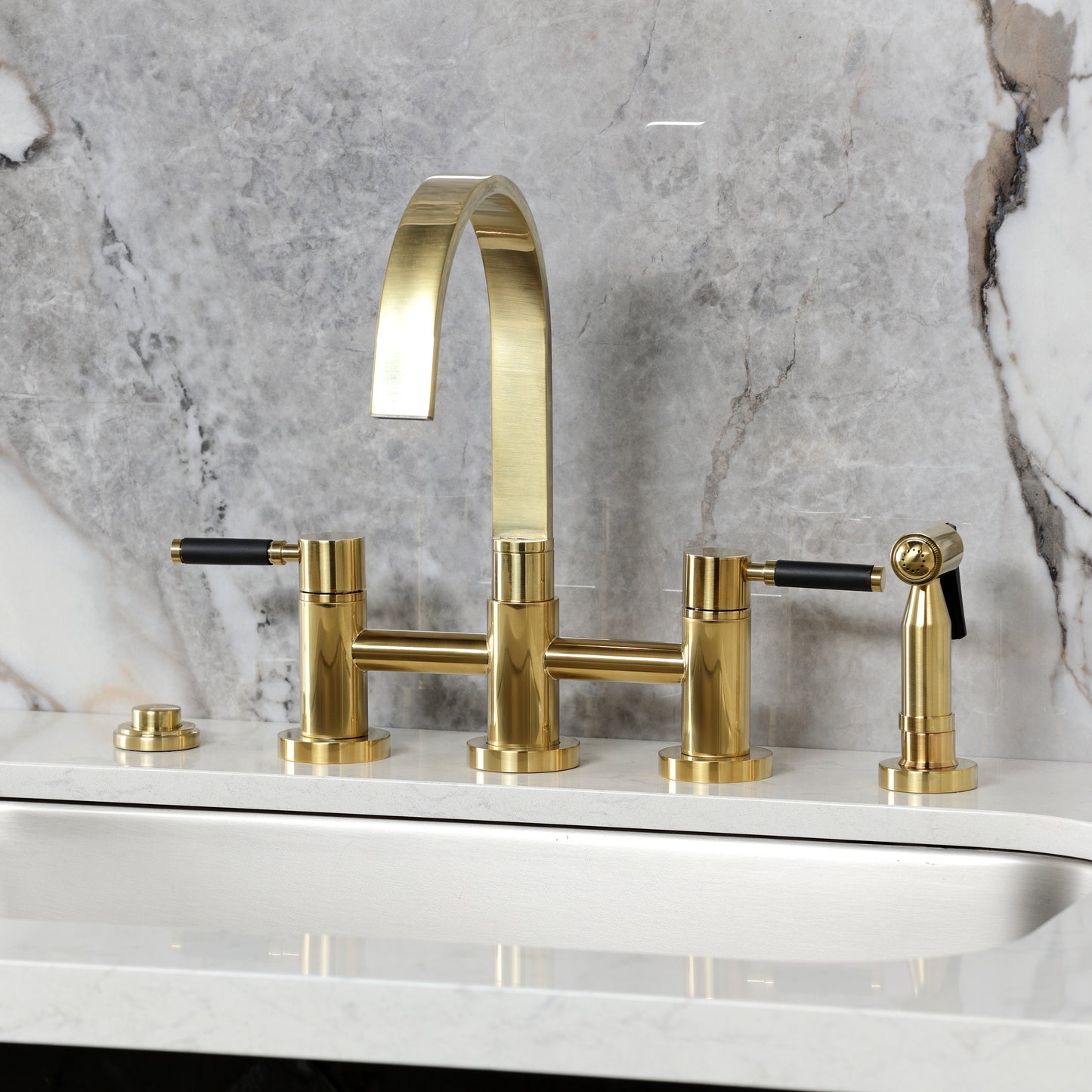 Kingston KS8267DKLBS Kaiser Bridge Kitchen Faucet with Brass Sprayer, Brushed Brass on a marble countertop.
