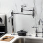 Kingston Brass KS3703AL Restoration Deck Mount Pot Filler Faucet, Antique Brass in a kitchen setting.