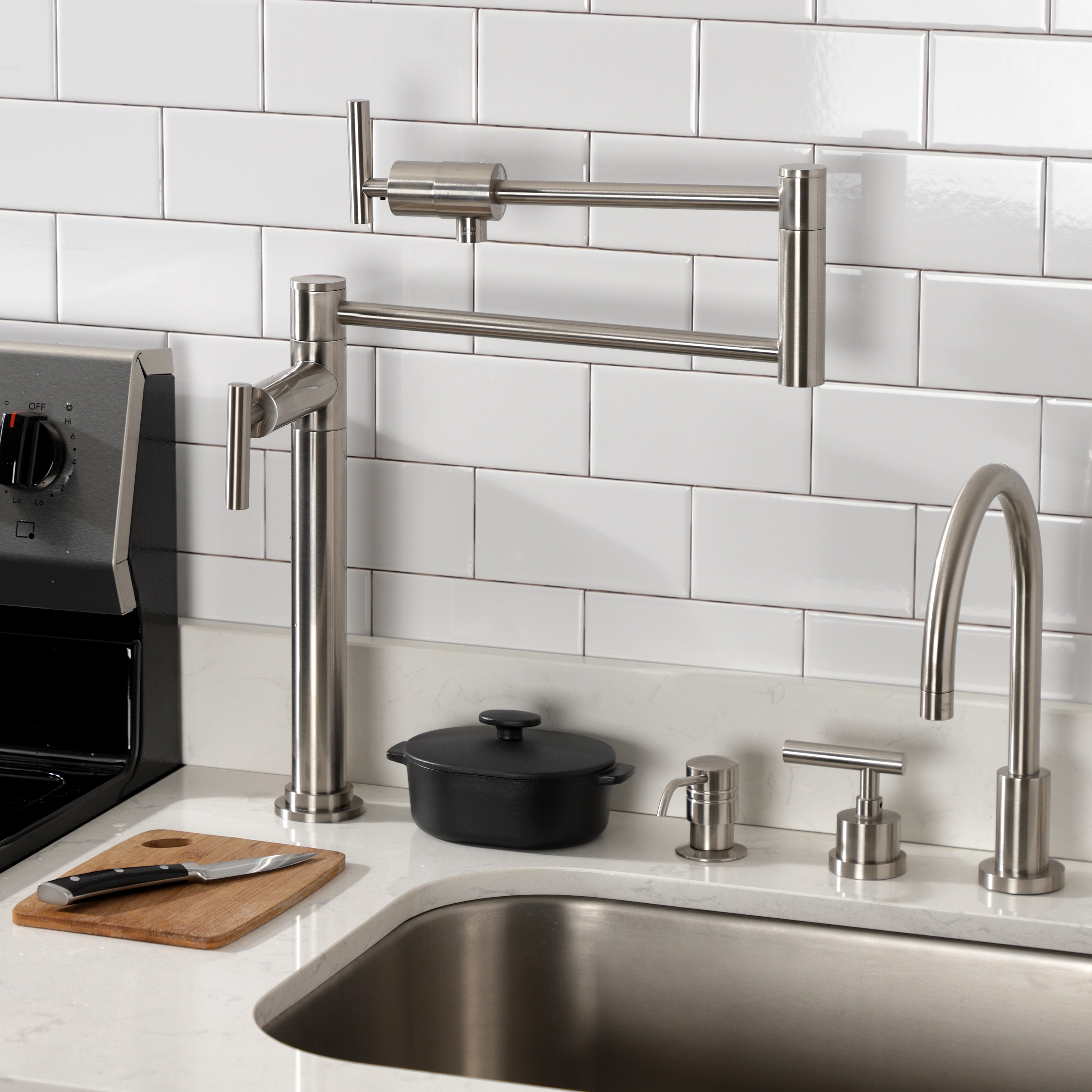 Kingston Brass KS4703CML Manhattan Deck Mount Pot Filler Faucet, Antique Brass showcased in a modern kitchen setting.