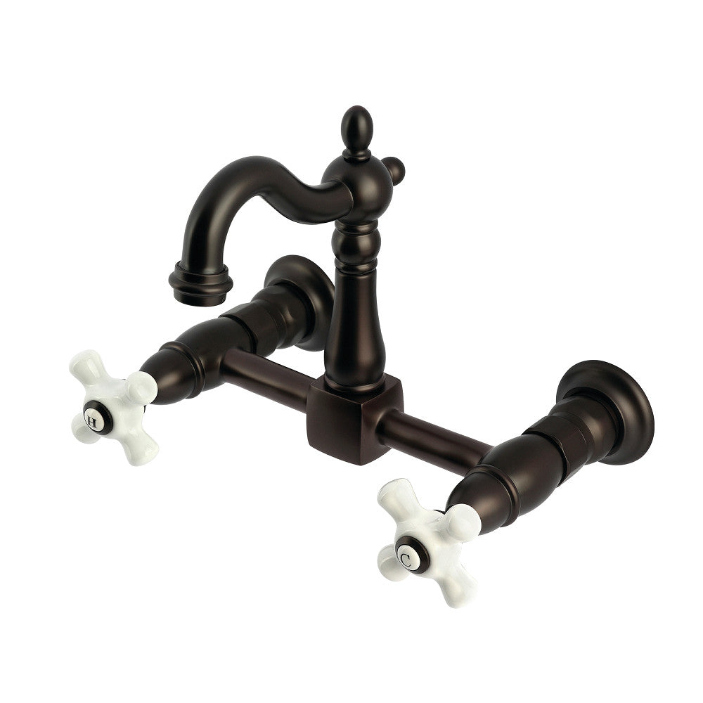 Kingston KS2443PX Heritage Two-Handle Wall Mount Bridge Kitchen Faucet, Antique Brass with porcelain cross handles.