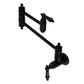Kingston Brass KS3103PKL Duchess Wall Mount Pot Filler Faucet, Antique Brass with black porcelain handles and foldable swing arms.